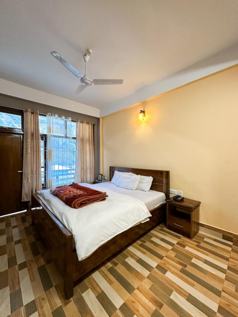  Private single room in Tawang with warm bedding and mountain views.